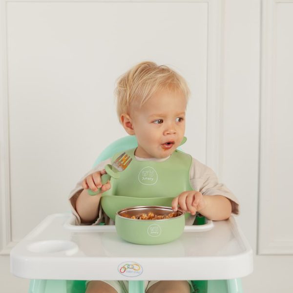 Toddler using Junary fork and spoon set designed for self-feeding and baby-led weaning