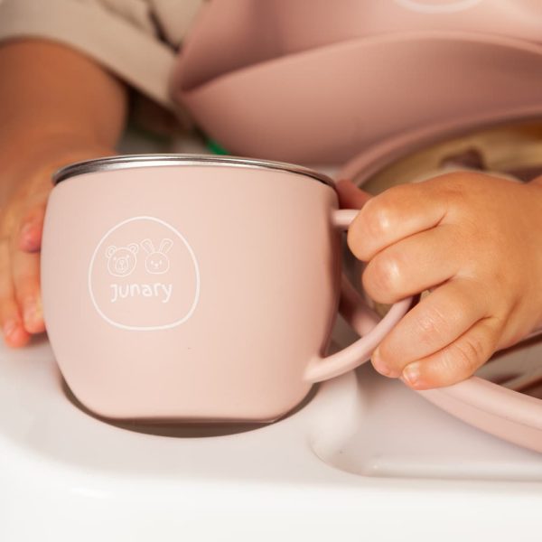 Toddler holding a stainless steel cup with removable silicone sleeve by Junary