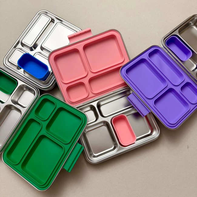Junary Balanced Bites stainless steel bento lunchboxes in pink, purple and blue with leak-resistant silicone seals.